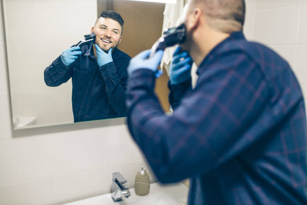 istock Man shaving with electric razor 1222101122