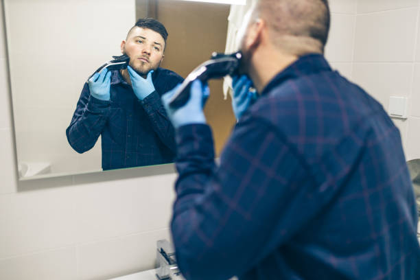 istock Man shaving with electric razor 1222101207