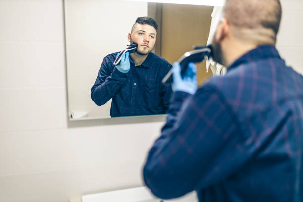 istock Man shaving with electric razor 1222101388