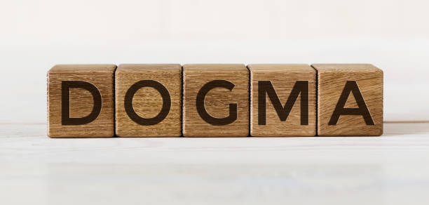 istock DOGMA word concept written on a light table and light background 1222101417