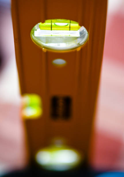 Close up macro shot of the yellow green liquid level against a background of natural light.