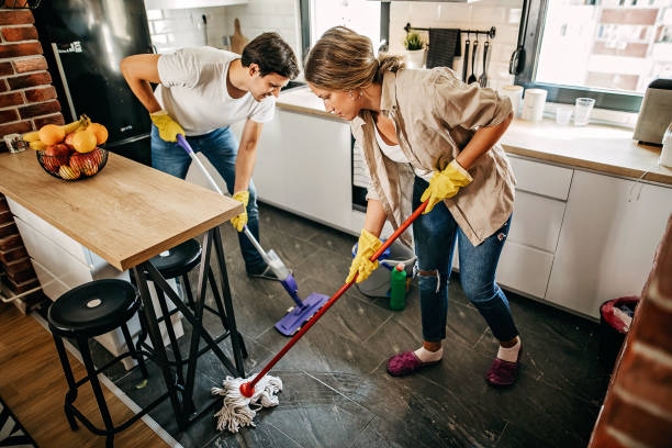 istock Couple cleaning floor in kitchen 1222102594