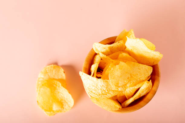 istock potato chips in a bowl on pink background 1222103266