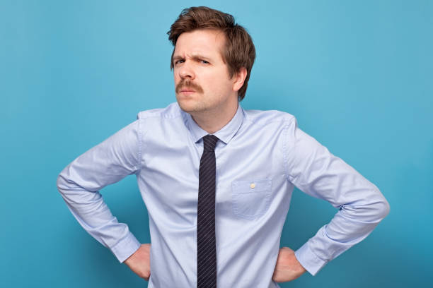 istock Angry, mad, annoyed businessman, isolated on blue background 1222105312