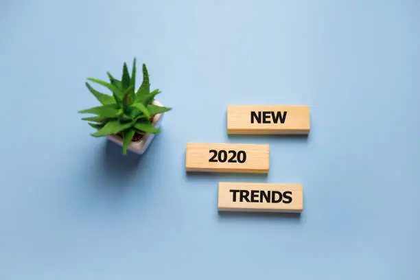 Photo of Wooden blocks with the word Trends 2020. Main trend of changing something. Popular and relevant topics. New ideological trends of fashion. Recent and latest trend. Evaluation methods. Fashionable