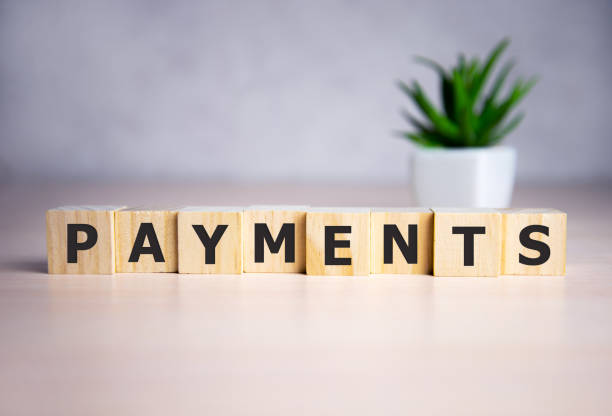 istock concept word payments on wooden cubes on a beautiful background 1222106301