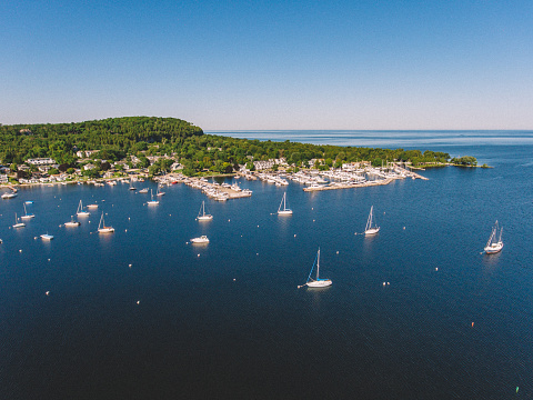 Aerial drone photography showing sailboats in the Fish Creek Harbor in Door County, Wisconsin on a summer day.