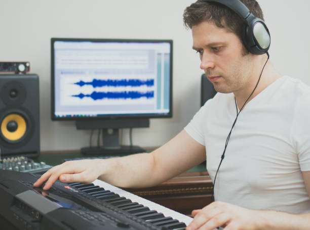 istock Handsome man recording song in music studio. 1222107773