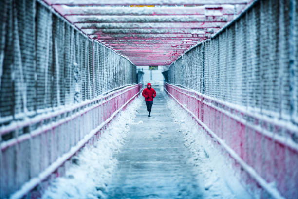 Man running in winter on the Williamsburg bridge in New YOrk Man running in winter on the Williamsburg bridge in New York williamsburg bridge stock pictures, royalty-free photos & images