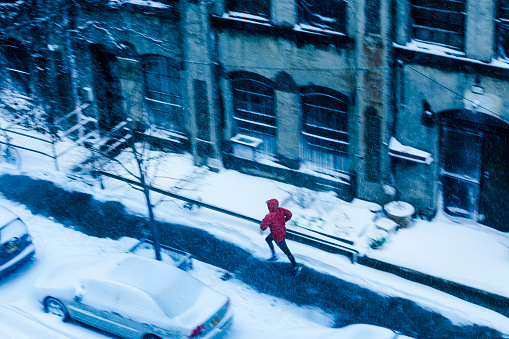 Man running in winter in New York with motion blur