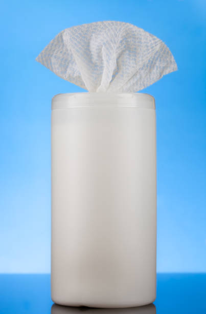Dispensing container with bleach sanitizing wipes on blue background stock photo