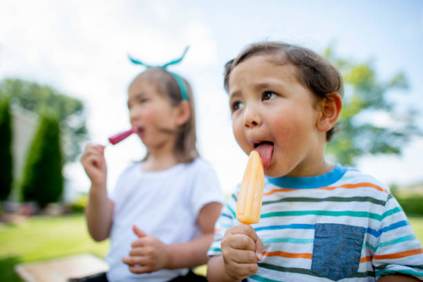 istock Cute kids eating ice cream 1222112252