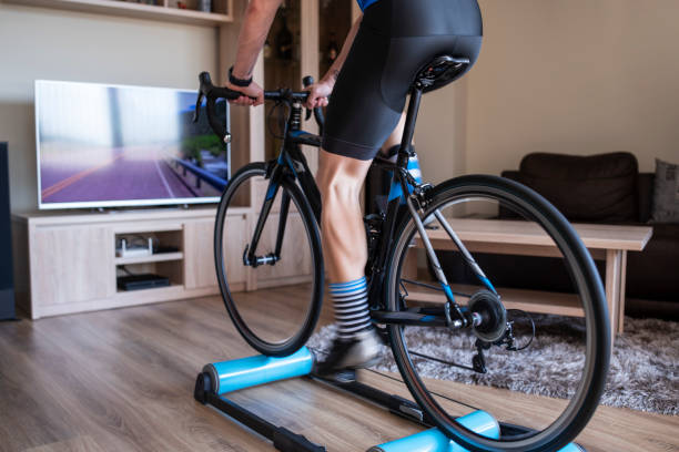istock Man Cycling Indoor With Exercise Bike Trainer. 1222113632