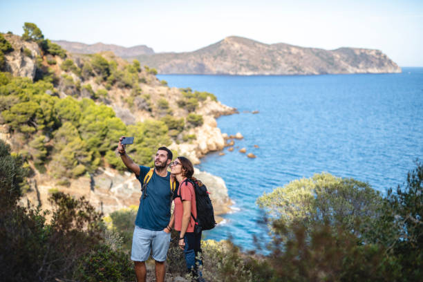 istock Young Hikers Pausing for Selfie on Mediterranean Coast 1222113728