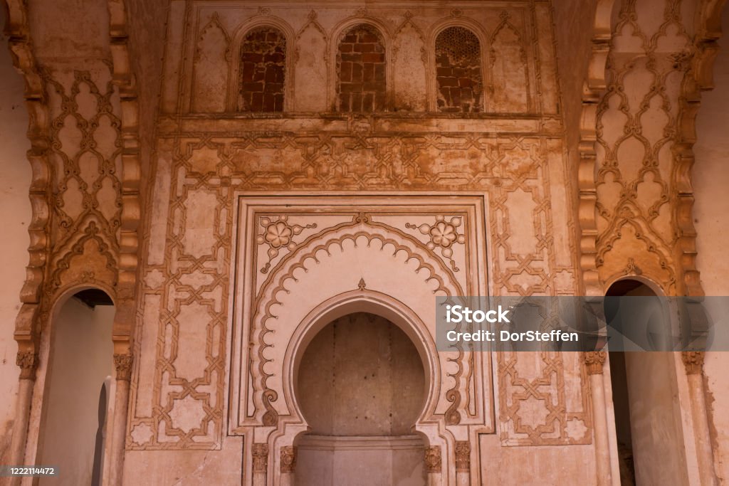 Wall with Mihrab of Public Old Almohad Tin Mal Mosque in Morocco Ornate wall with Mihrab of public old Almohad Tin Mal Mosque in Morocco. The historical building was built during the Almohad period. Mosque Stock Photo