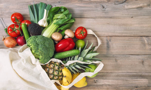 istock Fresh vegetables fruits cotoon bag Tomato cucumber broccoli pineapple avocado 1222116263