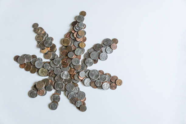 istock A marijuana leaf made of US American coins on solid white background with blank empty room space for copy, text, or copyspace. Taxing cannabis may bring economic revenue in the USA. 1222120354
