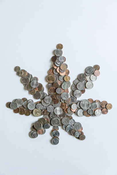 istock A marijuana leaf made of US American coins on solid white background with blank empty room space for copy, text, or copyspace. Taxing cannabis may bring economic revenue in the USA. 1222120358
