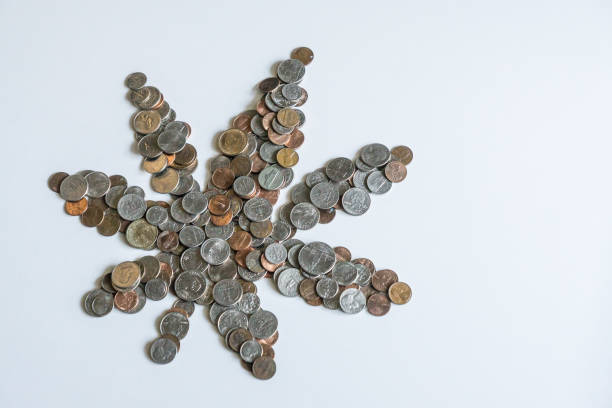 istock A marijuana leaf made of US American coins on solid white background with blank empty room space for copy, text, or copyspace. Taxing cannabis may bring economic revenue in the USA. 1222120363