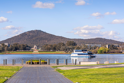 Canberra, ACT, Australia - Sep 22, 2019:\nA Pleasure Cruiser is passing through central of Lake Burley Griffin at a sunny day in Canberra.