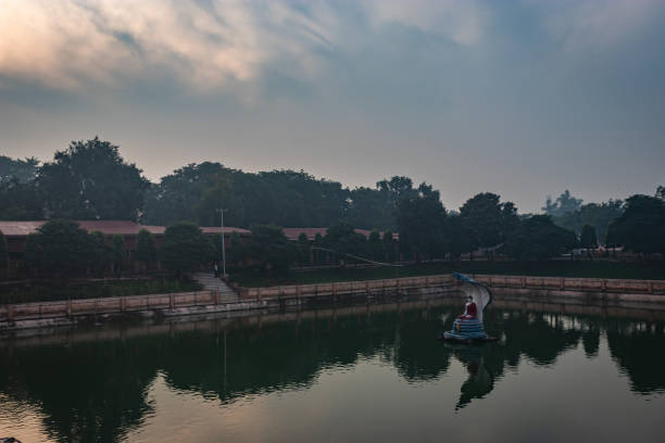 istock Budhha statue at lake isolated with bright sky and unique prospective 1222122899