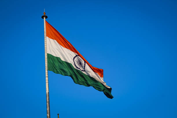 istock A Indian flag flying front of india get with clean blue sky and sun light. 1222123056