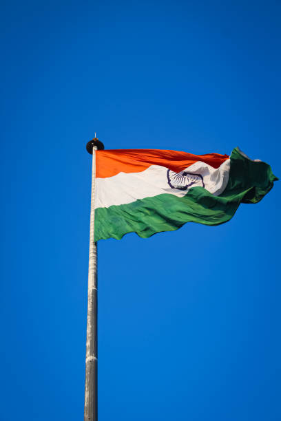 istock A Indian flag flying front of india get with clean blue sky and sun light. 1222123063