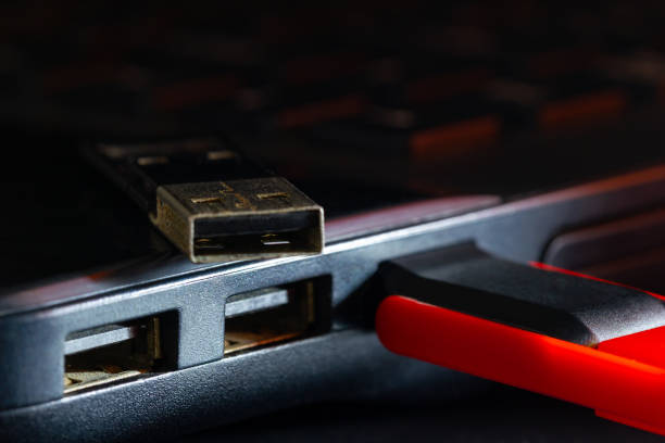 istock Flash drive in USB port of computer notebook in darkness. 1222127535