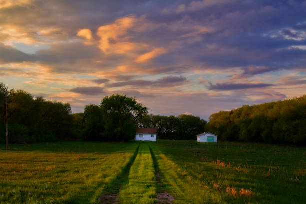 istock Green grass path to old homestead 1222130509