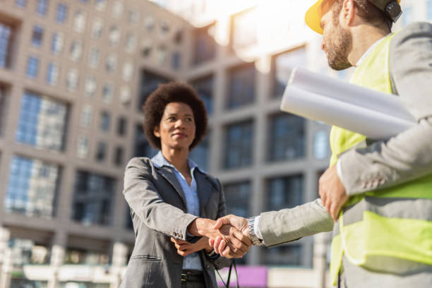 istock Business woman shaking hands with an engineer. 1222133016
