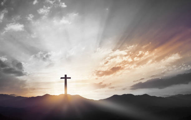 Christmas concept: Crucifixion Of Jesus Christ Cross At Sunset stock photo