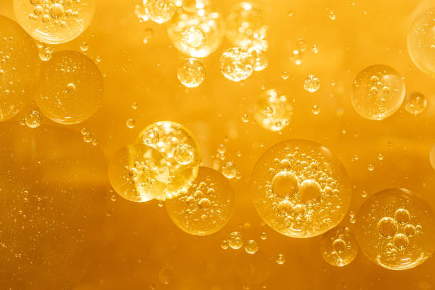 istock golden yellow bubble oil droplet, abstract background 1222139072