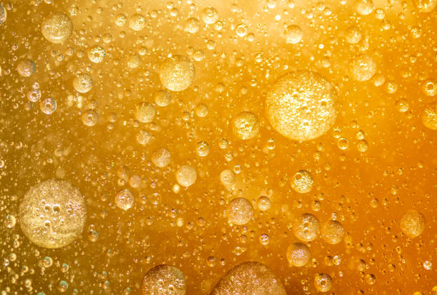 istock golden yellow bubble oil droplet, abstract background 1222139075
