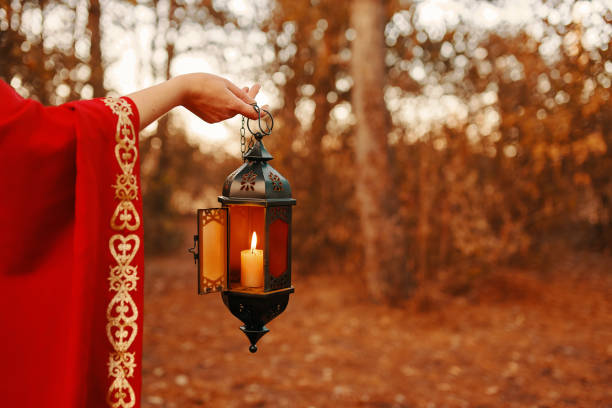 istock Woman holding a lantern with a candle. 1222141804