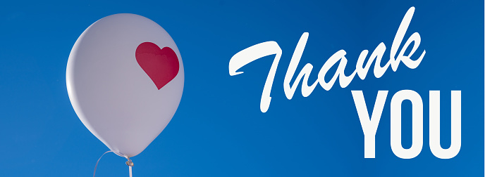 thank you phrase and white air balloon with red heart over clear sky background