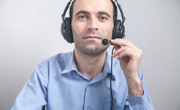 istock Call center worker man wear earphones. 1222144675