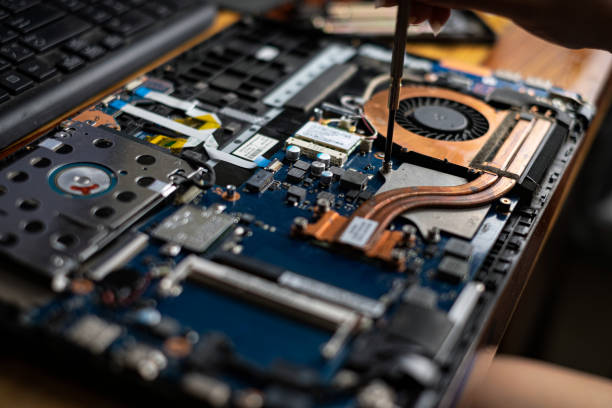 istock Hand technician repairing broken laptop notebook computer with a screwdriver 1222147017