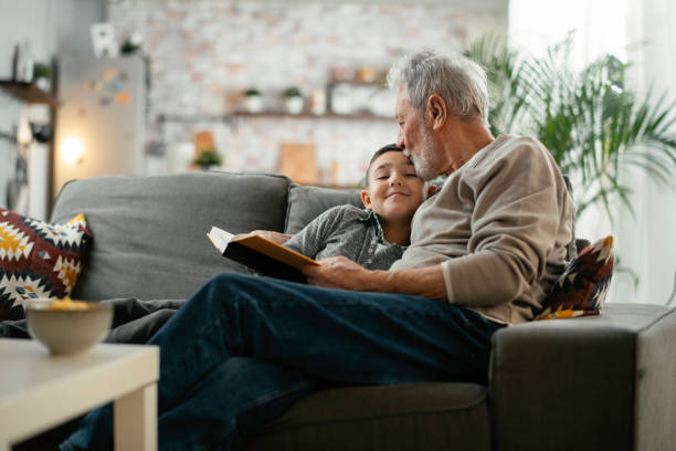 istock Grandpa and grandson reading book together. 1222151271