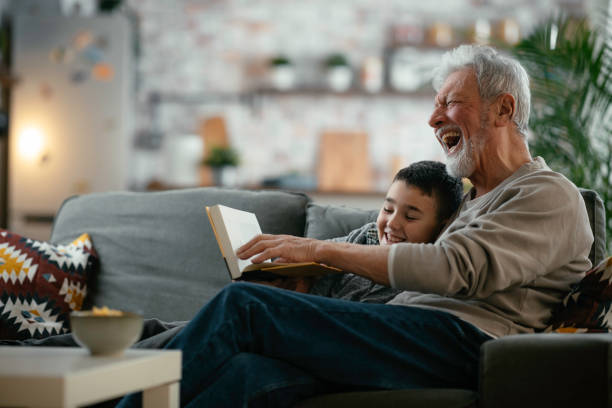 istock Grandpa and grandson reading book together. 1222151288