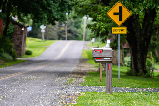 a traditional American mailbox on the side of a village road in Penfield, NY