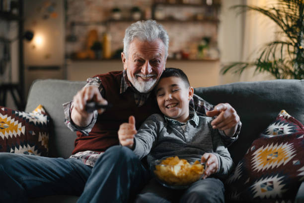 istock Grandfather and grandson watching television 1222151549