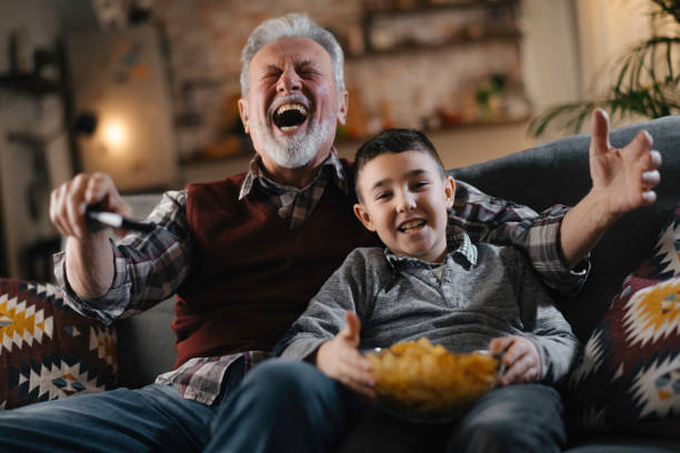 istock Grandfather and grandson watching television 1222151582