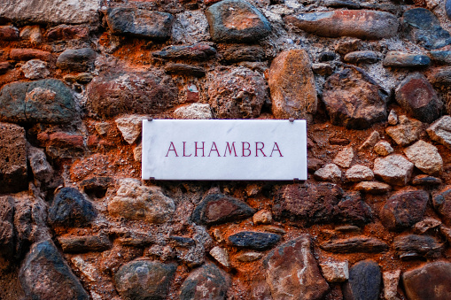 Marble poster of the Alhambra of Granda on a stone wall