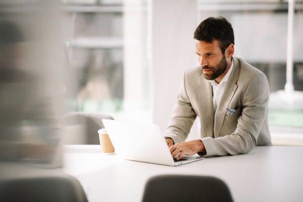 istock Handsome businessman drinking coffe and working on lap top. 1222155930