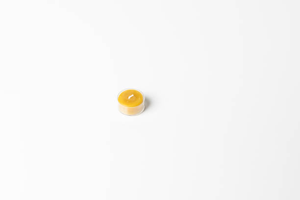 istock Small honey candle isolated on white background. 1222156011