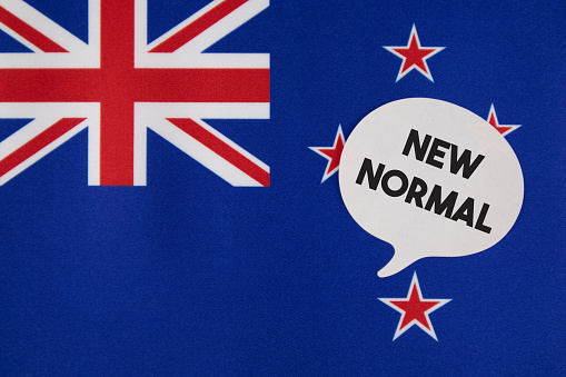 New Normal After Coronavirus. New Normal speech bubble note paper on the Australian Flag. Horizontal composition with copy space. Global Health and COVID-19 pandemic concept.