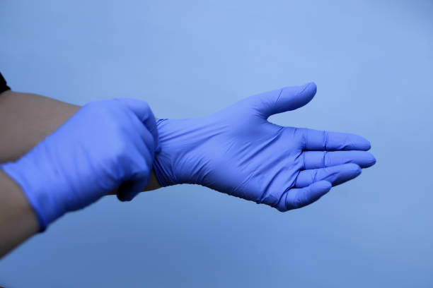 istock Human hands with blue protective gloves stock image 1222157548