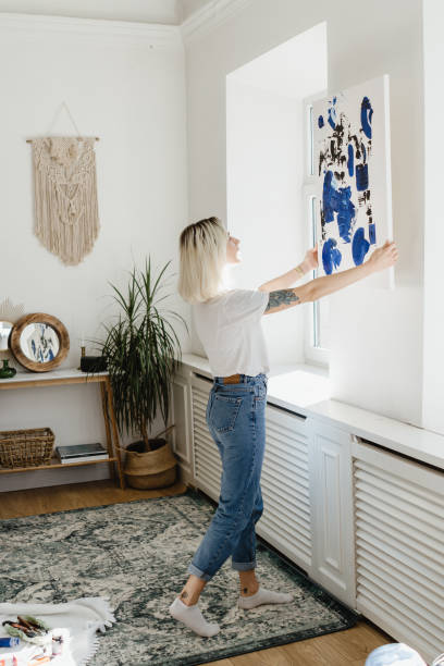 istock Young woman placing abstract paint on the wall 1222158537