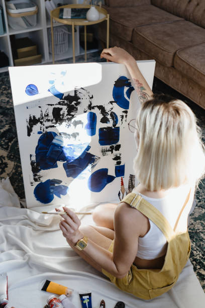 istock Beautiful young woman artist drawing 1222158553