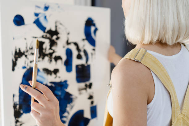istock Beautiful young woman artist drawing 1222158563